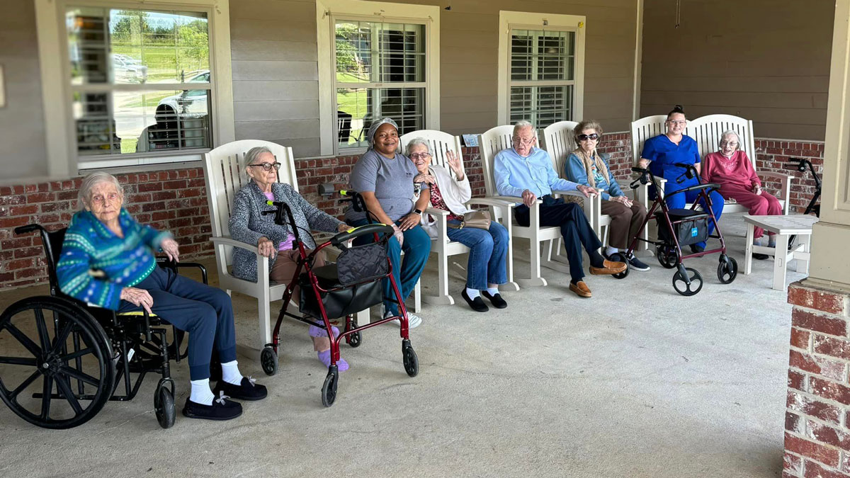 Elders Sitting on Patio at Green House Cottages of Belle Meade